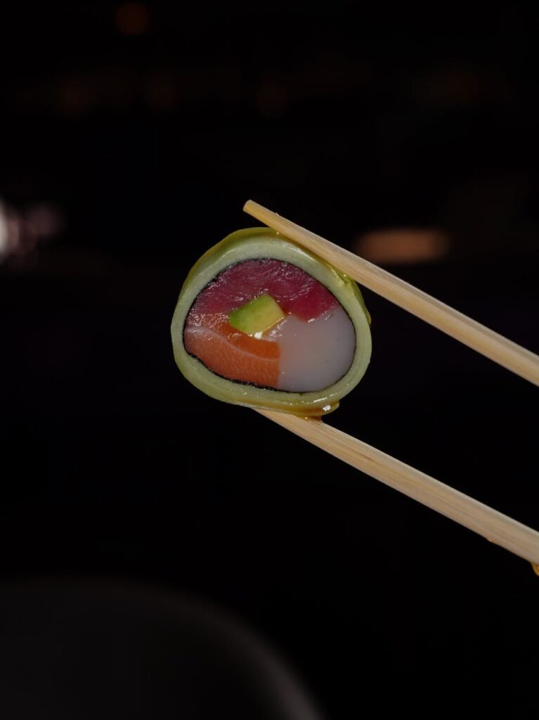 sushi held with chopsticks