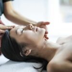 selective focus photo of woman getting a head massage