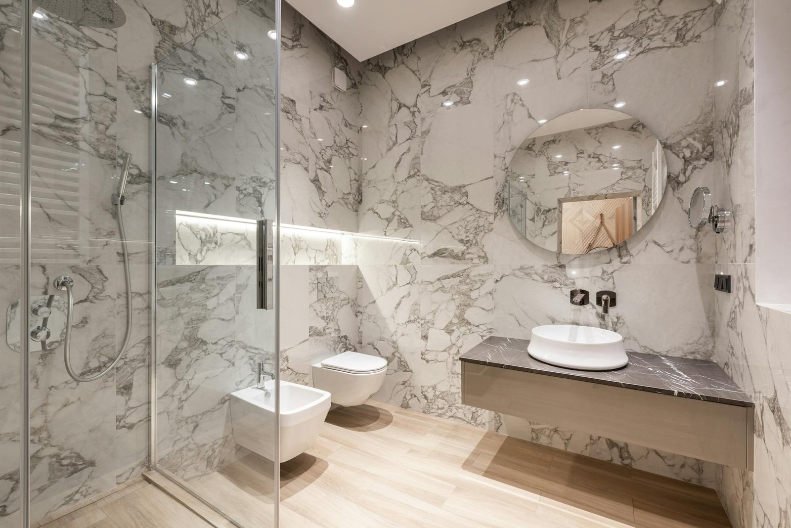 bathroom interior with bidet and toilet near sink and shower