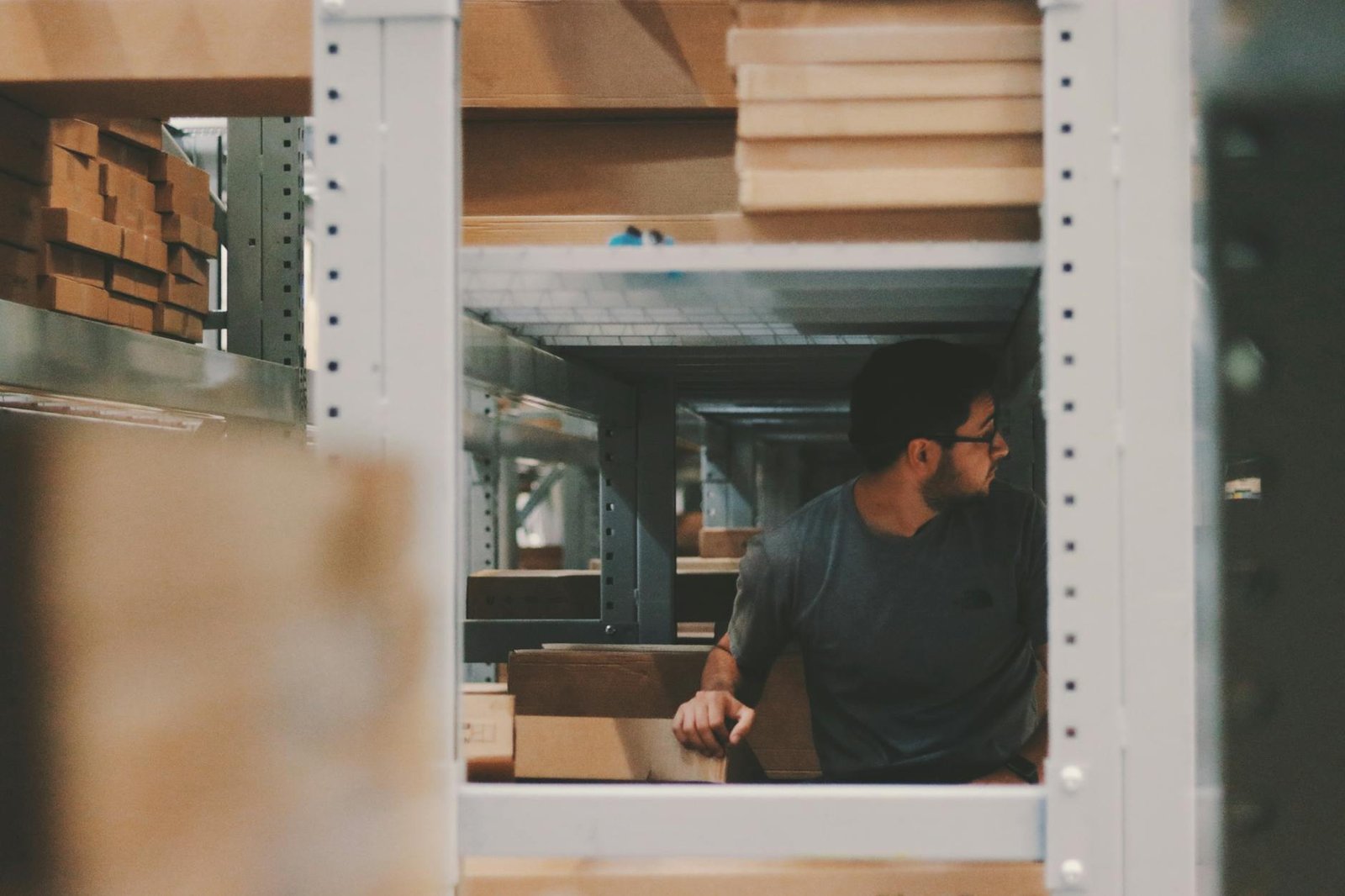 man under a bunch of large shelves