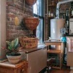 interior of kitchen with brick wall decorated with wicker baskets