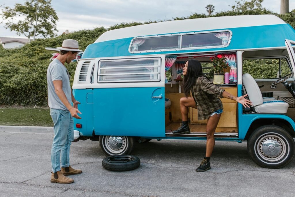 couple arguing over a flat tire in their campervan