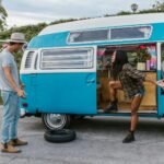 couple arguing over a flat tire in their campervan